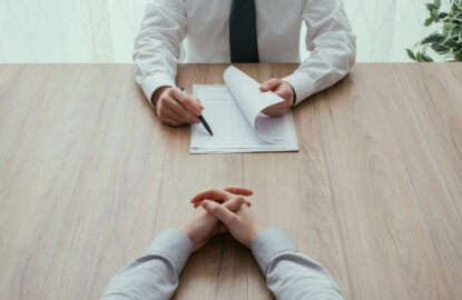 Job interview Examiner reading a resume during a job interview, employment and recruitment concept, point of view shot